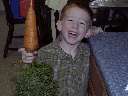 Dean holding carrot from garden